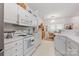Bright kitchen with white cabinets, appliances, countertops, and a connected dining area for cozy meals at 12350 Swan Wings Pl, Huntersville, NC 28078