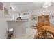 Open-concept kitchen with breakfast bar, modern appliances, and seamless flow to dining area and other living spaces at 12350 Swan Wings Pl, Huntersville, NC 28078