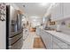 Kitchen with white cabinets, stainless steel refrigerator, and dining area at 12350 Swan Wings Pl, Huntersville, NC 28078