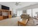 Living room with plush furniture, wood shelving, and French doors at 12350 Swan Wings Pl, Huntersville, NC 28078