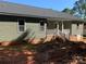 Exterior view of a house with siding, windows, a dark roof, and stairs leading to the backyard at 136 Ridge Run Dr, Statesville, NC 28625