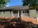 An exterior view of the rear of the home featuring siding, white railings, and stairs to the backyard at 136 Ridge Run Dr, Statesville, NC 28625