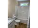 Bathroom featuring granite countertop, white cabinets, a tub with shower, and light walls at 136 Ridge Run Dr, Statesville, NC 28625