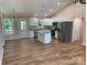 Open floor plan of kitchen featuring white cabinets, stainless steel appliances, and a kitchen island at 136 Ridge Run Dr, Statesville, NC 28625