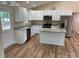 Kitchen features white cabinets, granite countertops, stainless steel appliances, and island at 136 Ridge Run Dr, Statesville, NC 28625