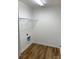 Utility room with wood flooring, washer hookups, and open shelving at 136 Ridge Run Dr, Statesville, NC 28625