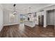 Modern kitchen with white cabinets, quartz countertops, stainless steel appliances, hardwood floors, and island seating at 1644 Dresden St, Rock Hill, SC 29732