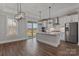 Modern kitchen featuring a large island, stainless steel appliances, pendant lighting, and hardwood floors at 1644 Dresden St, Rock Hill, SC 29732
