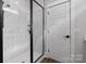 Modern marble tiled shower with frameless glass door and black hardware at 1644 Dresden St, Rock Hill, SC 29732
