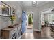 Welcoming entryway with a blue front door, hardwood floors, elegant decor, and access to the living spaces at 17112 Courtside Landing Dr, Cornelius, NC 28031