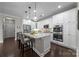 Charming kitchen featuring stainless steel appliances, white cabinets, granite countertops, and pendant lighting at 17112 Courtside Landing Dr, Cornelius, NC 28031