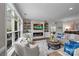 Comfortable living room with a stone fireplace, built-in shelving, hardwood floors, and ample natural light at 17112 Courtside Landing Dr, Cornelius, NC 28031