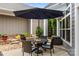 Back patio area with outdoor seating and umbrella at 17112 Courtside Landing Dr, Cornelius, NC 28031