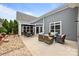 Rear patio featuring an outdoor dining area and lounge seating at 17112 Courtside Landing Dr, Cornelius, NC 28031
