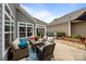 Covered patio area with outdoor seating and landscaping at 17112 Courtside Landing Dr, Cornelius, NC 28031