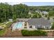 Aerial shot of community pool and clubhouse with lounge area, lush greenery, and a fenced perimeter at 17112 Courtside Landing Dr, Cornelius, NC 28031