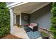 Inviting porch with comfortable seating, a stylish rug, and decorative plants, perfect for relaxing outdoors at 17112 Courtside Landing Dr, Cornelius, NC 28031