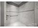 Modern shower featuring marble-look tiling, a built-in bench and stylish fixtures at 17112 Courtside Landing Dr, Cornelius, NC 28031