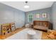 Charming Bedroom with a wooden crib, cozy reading nook, and soft, neutral colors at 1723 Woodland Dr, Charlotte, NC 28205
