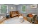 Serene Bedroom features a wooden crib, accent chair, and calming gray tones at 1723 Woodland Dr, Charlotte, NC 28205