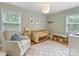 Charming Bedroom with a crib, comfortable seating, and bright natural light at 1723 Woodland Dr, Charlotte, NC 28205