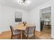 Bright dining area with round table, stylish chairs, modern lighting, and view into adjacent room at 1723 Woodland Dr, Charlotte, NC 28205