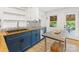 Well-appointed kitchen with custom cabinetry, butcher block countertops, and modern stainless steel appliances at 1723 Woodland Dr, Charlotte, NC 28205