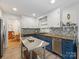 Stylish kitchen featuring a mix of white and blue cabinets, butcher block countertops, and patterned backsplash at 1723 Woodland Dr, Charlotte, NC 28205