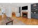 Open concept living room showcasing a fireplace, built-in shelving, and seamless access to the dining area at 1723 Woodland Dr, Charlotte, NC 28205
