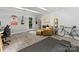 Living space featuring stylish rug, comfortable seating, decor, and workout equipment for a versatile area at 1723 Woodland Dr, Charlotte, NC 28205