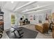 Spacious living space with white ceiling beams, desk, workout equipment, and comfortable seating area at 1723 Woodland Dr, Charlotte, NC 28205