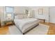 Spacious bedroom featuring hardwood floors, neutral tones, and plenty of natural light from the windows at 1723 Woodland Dr, Charlotte, NC 28205