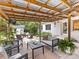 Relaxing covered patio with comfortable seating, a dining table, and a lush garden backdrop at 1723 Woodland Dr, Charlotte, NC 28205