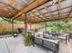 Outdoor covered patio with a dining area, lounge seating, and well-manicured yard at 1723 Woodland Dr, Charlotte, NC 28205