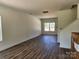 Open-concept living room with large window and vinyl flooring, perfect for entertaining at 2300 Grayson Pkwy, Monroe, NC 28110