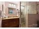 Well-lit bathroom with a granite vanity, glass shower, and decorative accents at 2533 Stockbridge Dr, Charlotte, NC 28210