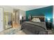 Comfortable bedroom featuring a teal accent wall, stylish decor, and natural light at 2533 Stockbridge Dr, Charlotte, NC 28210