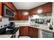 Modern kitchen featuring dark wood cabinets, stainless steel appliances and granite countertops at 2533 Stockbridge Dr, Charlotte, NC 28210