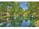 Beautiful pond reflecting surrounding trees and buildings, creating a serene landscape at 2533 Stockbridge Dr, Charlotte, NC 28210