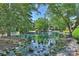 Charming pond with fountain feature and rock accents provides a serene and picturesque outdoor space at 2533 Stockbridge Dr, Charlotte, NC 28210