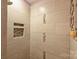 Detailed view of a modern shower with neutral tile and mosaic accents at 2533 Stockbridge Dr, Charlotte, NC 28210