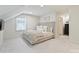 Serene bedroom with plush carpeting, a tufted headboard, and soft, neutral tones for a calming atmosphere at 2919 Wickersham Rd, Charlotte, NC 28211