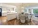 Open-concept dining area showcases a round table with decorative chairs, adjacent to the kitchen and living room at 2919 Wickersham Rd, Charlotte, NC 28211