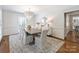 Chic dining room features a decorative chandelier, large window, and an ample table at 2919 Wickersham Rd, Charlotte, NC 28211