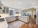 Bright, modern kitchen features white cabinetry, stainless steel appliances, and an open layout to the dining area at 2919 Wickersham Rd, Charlotte, NC 28211