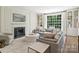 Bright living room features a large window, fireplace, and comfortable seating with a neutral color palette at 2919 Wickersham Rd, Charlotte, NC 28211
