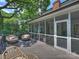 Charming back porch with ample seating overlooking the beautiful backyard at 2919 Wickersham Rd, Charlotte, NC 28211