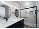 Modern bathroom featuring a double vanity, black fixtures, and a luxurious shower with unique tile design at 304 Cabarrus W Ave, Concord, NC 28025