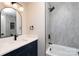 Modern bathroom featuring a single vanity, black fixtures, and a luxurious shower over tub with tile design at 304 Cabarrus W Ave, Concord, NC 28025
