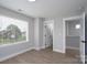 Bedroom with a large window, wood-look flooring, and a walk-in closet at 304 Cabarrus W Ave, Concord, NC 28025